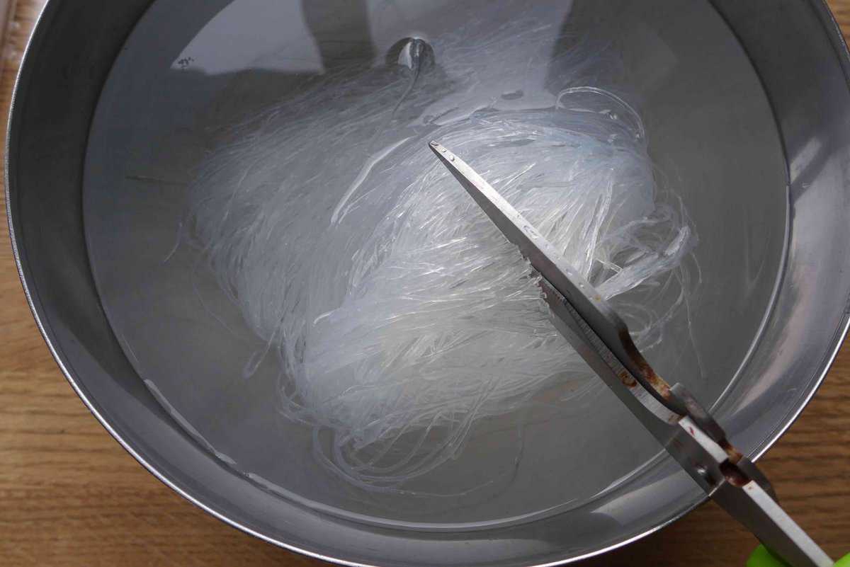 cutting rehydrated glass noodles.