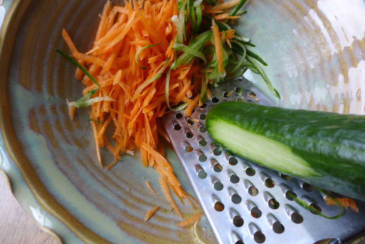 grating carrot and cucumber.