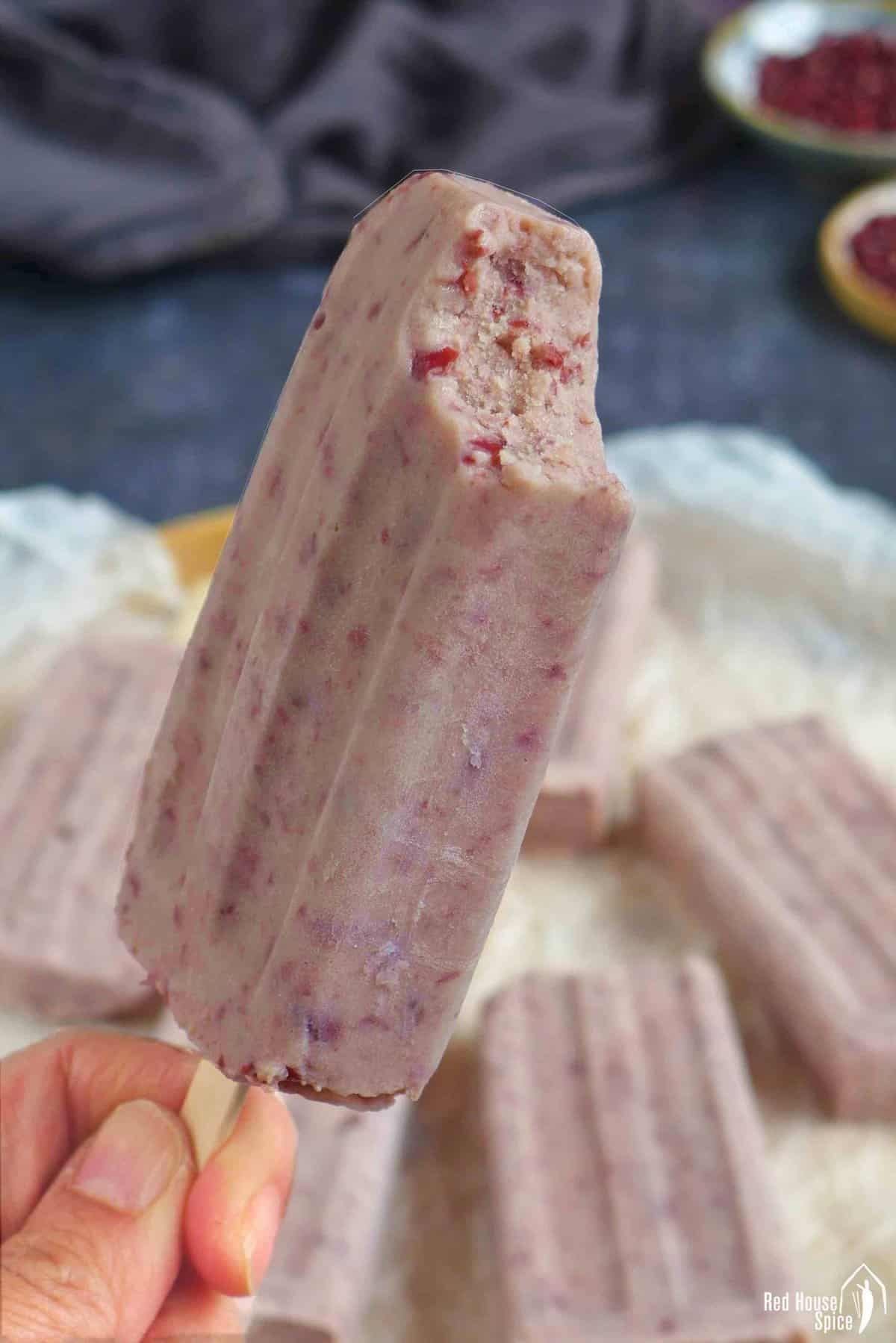one red bean popsicle bitten on the top.