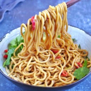 Pulling up Chinese sesame noodles with chopsticks.