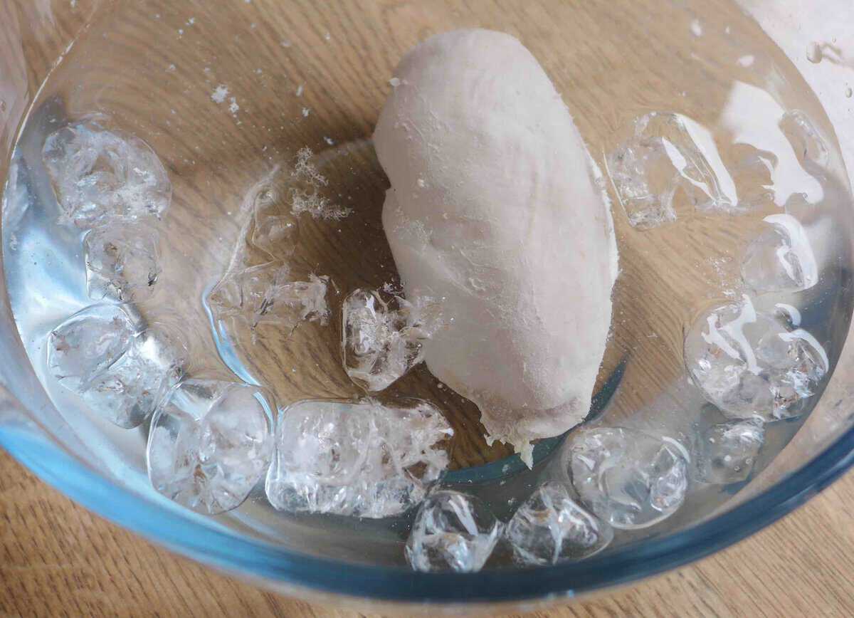cooked chicken breast in icy water.
