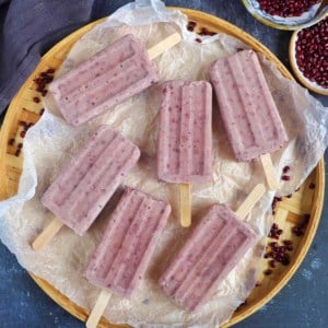 six red bean popsicles on a tray.