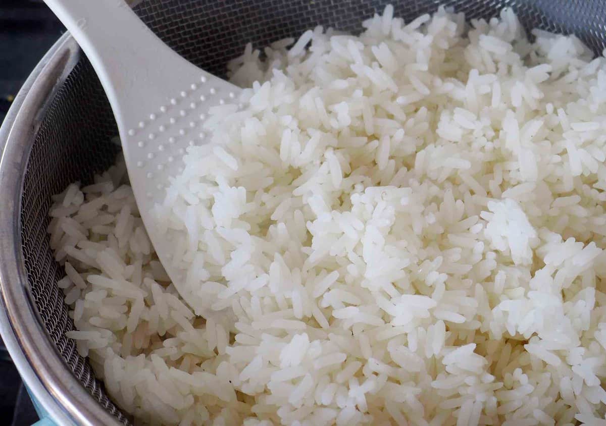 parboiled rice in a strainer.