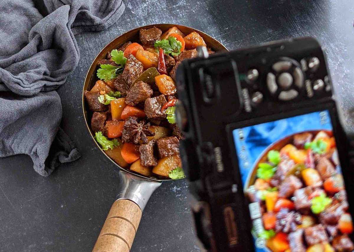 Taking a photo of Chinese beef stew with a camera.