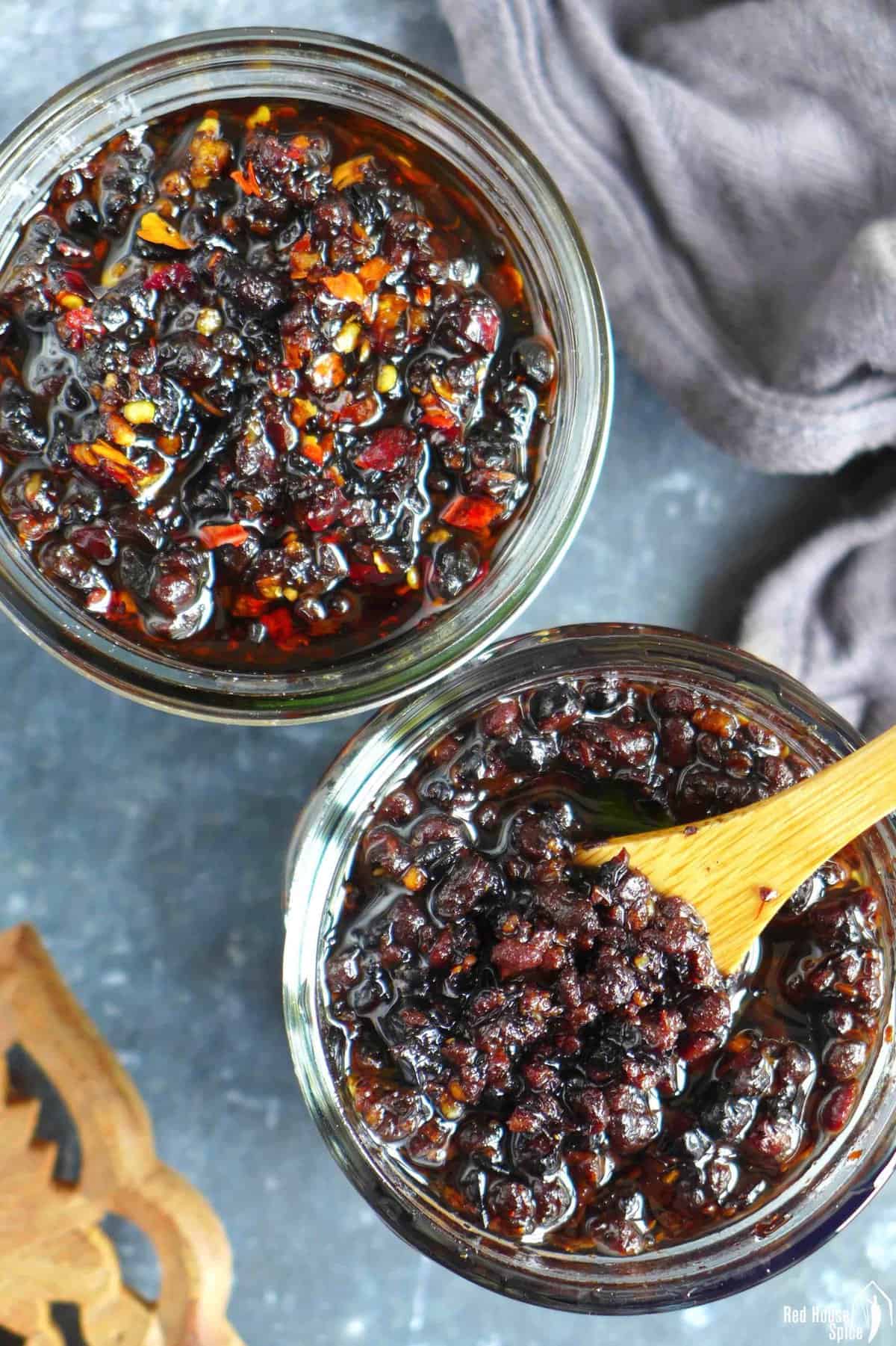 two jars of black bean sauce: one original and one spicy.