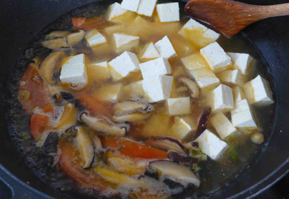 adding tofu to soup.