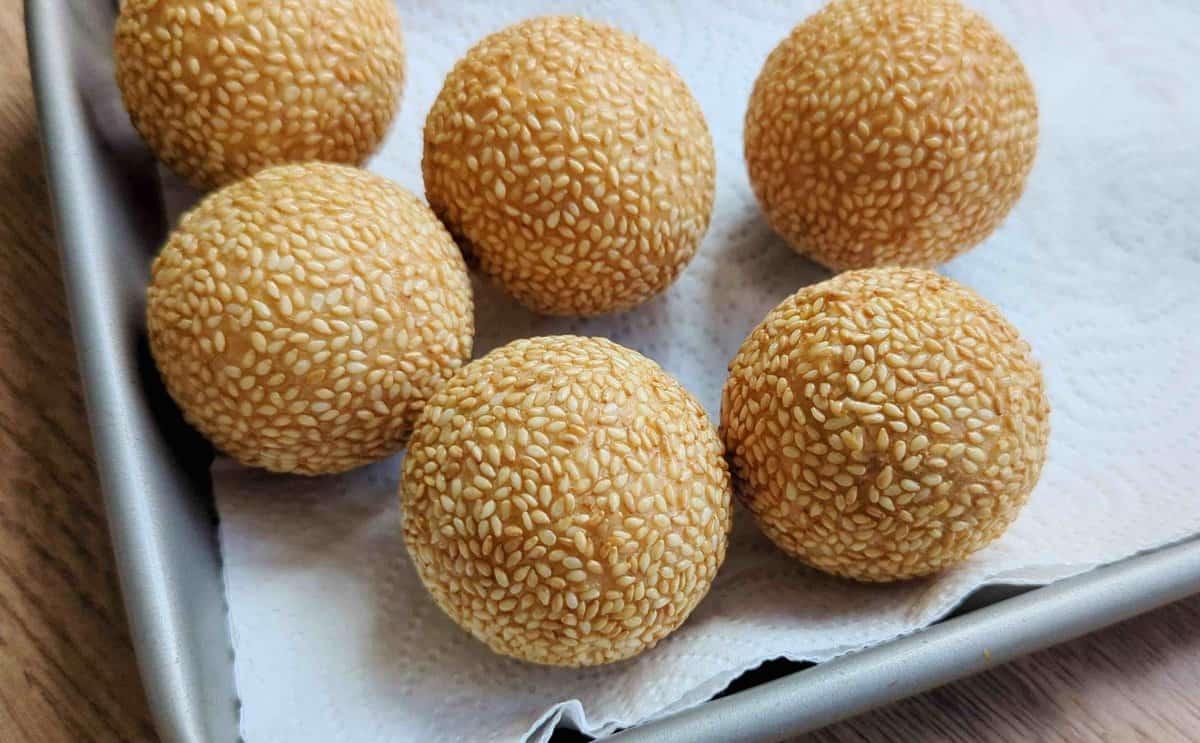 freshly fried sesame balls on a paper towel.