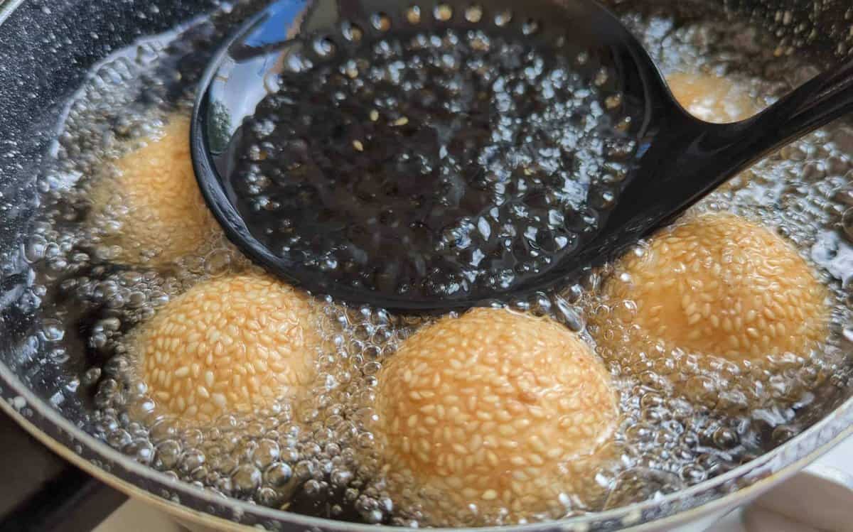 sesame balls turning golden in oil.