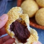 a sesame ball torn open with overlay text that says red bean sesame balls.