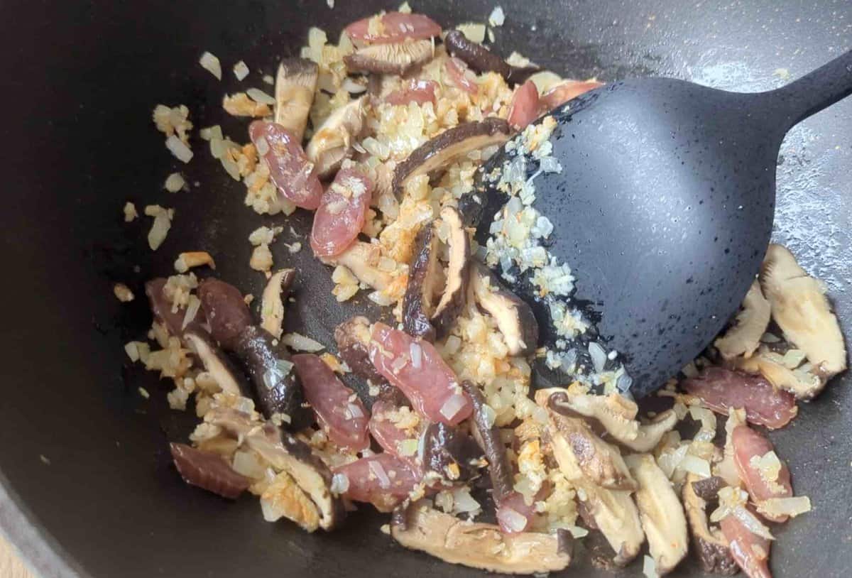 stir-frying aromatics, sausage and mushrooms.