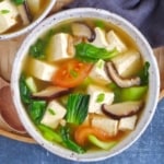 a bowl of Chinese tofu soup with vegetables.