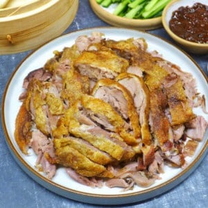 A plate of aromatic crispy duck cut into pieces.