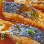 roast salmon pieces coated with sweet and sour sauce.