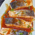 A plate of roast salmon with overlay text that says sweet and sour salmon.