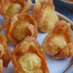 deep-fried wontons on a plate with overlay text that says fried wontons.