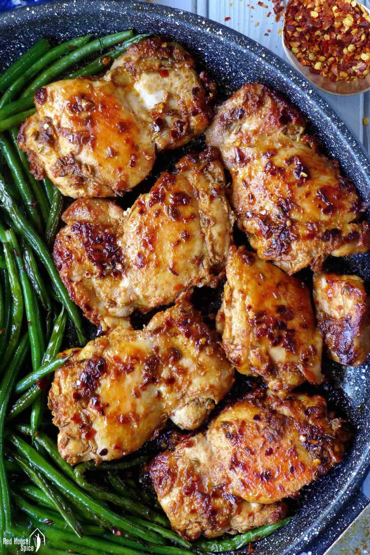 pan-fried chicken thighs with chili and cumin.