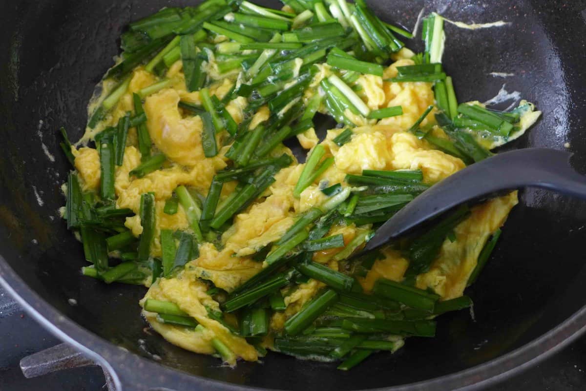 stir-frying eggs with chinese chives.
